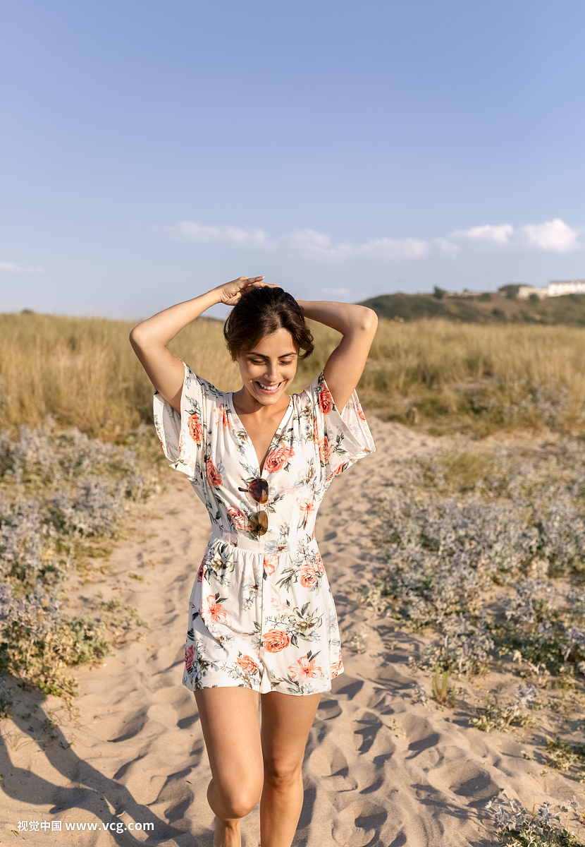 Smiling woman on the beach at evening twilight