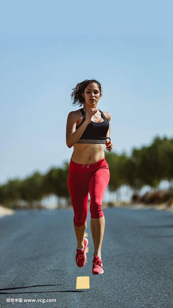 Female jogger running on asphalt